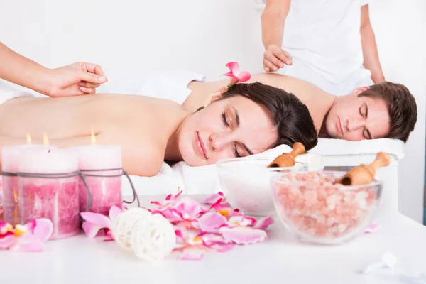 Couple Receiving An Acupuncture Treatment