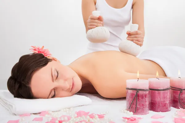 Woman Getting Herbal Compress Ball Therapy