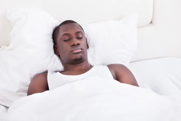 African Man Sleeping On Bed