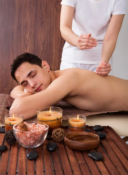 Relaxed Man Receiving Shoulder Massage In Spa
