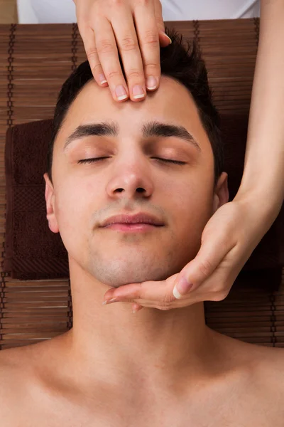 Man Receiving Head Massage From Massager In Spa