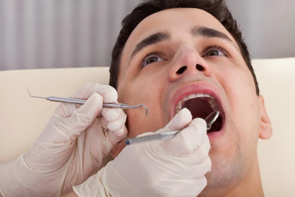 Cropped Image Of Dentist Examining Patient\'s Mouth