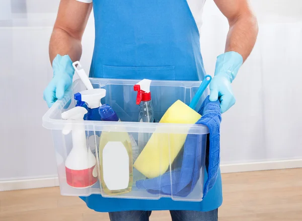 Janitor with a tub of cleaning supplies