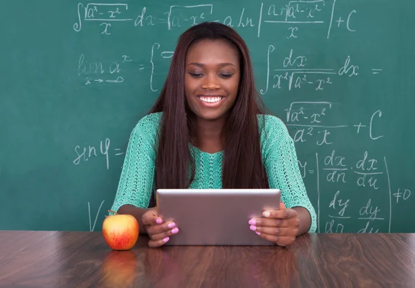 Teacher Holding Digital Tablet At School Desk