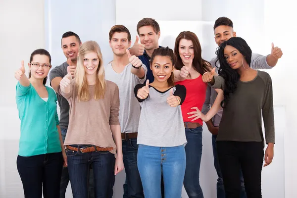 Confident College Students Gesturing Thumbs Up