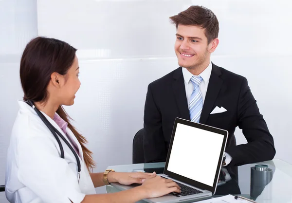Businessman Consulting Doctor