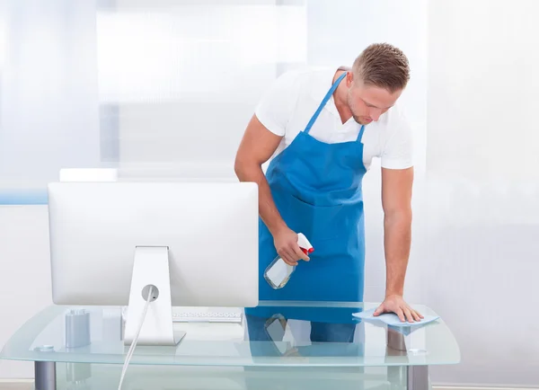 Janitor or cleaner cleaning an office