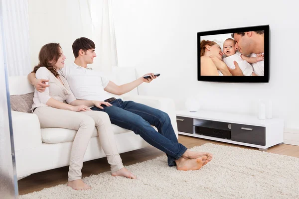 Couple In Livingroom Watching Television