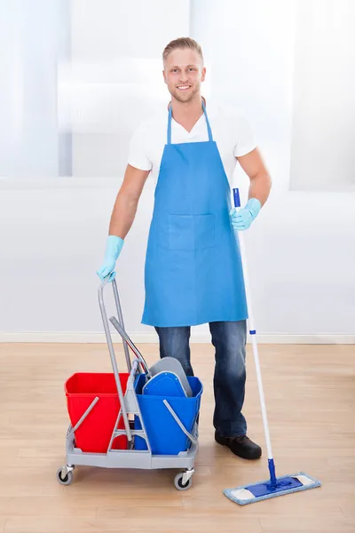 Janitor cleaning wooden floors