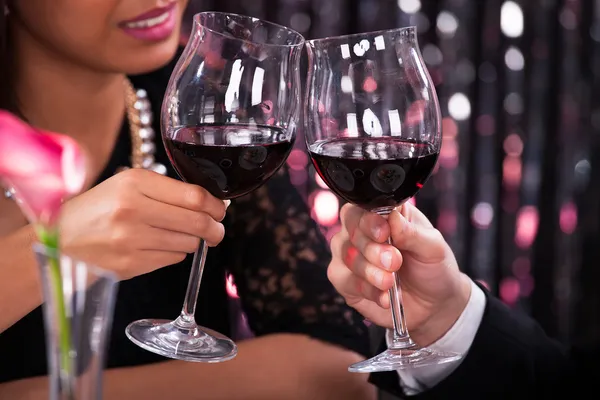 Couple Toasting Wineglasses In Restaurant
