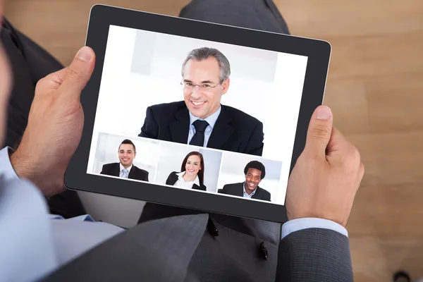 Businessman Video Conferencing With Coworkers