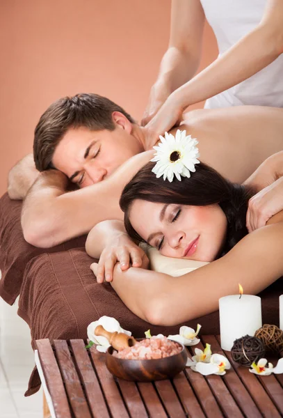 Couple Receiving Shoulder Massage At Spa