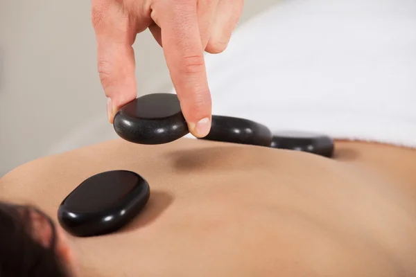 Woman Receiving Hot Stone Therapy