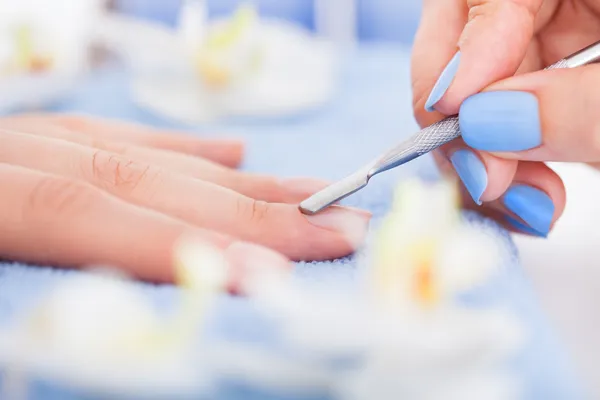Manicurist Removing Cuticle