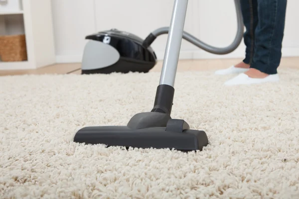Woman Vacuuming Floor