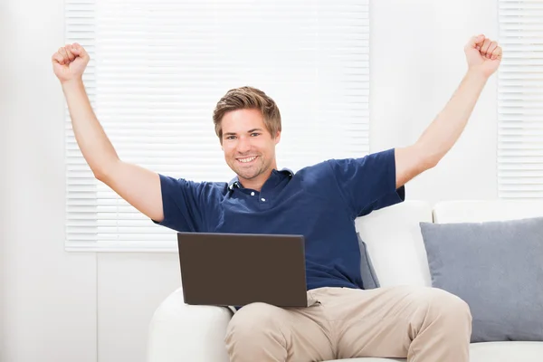 Man With Laptop Raising Hands