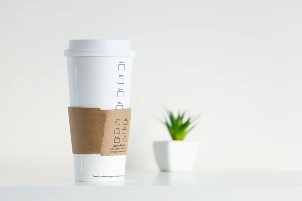 White Paper Cup and green potted plant
