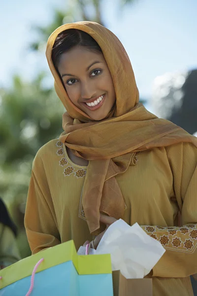 Muslim Woman Holding Shopping Bags