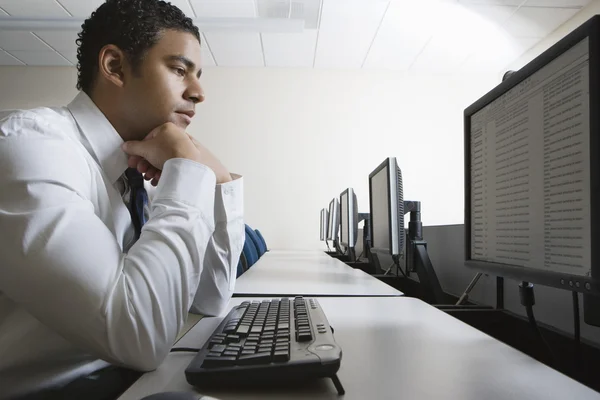 Businessman Sitting In Front Of Desktop PC