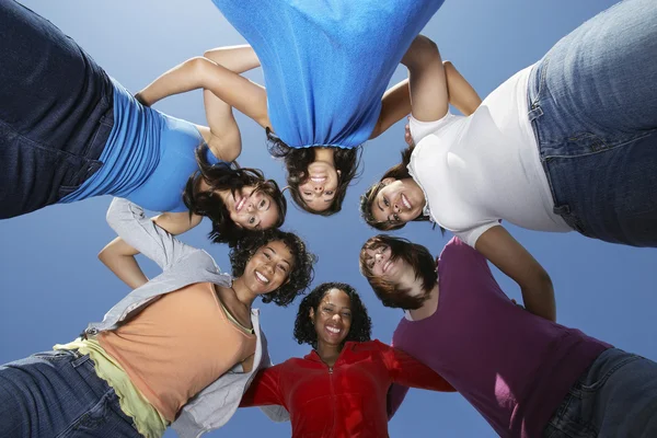 Young Women Standing In Circle