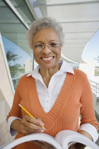 Female professor holding a book