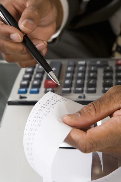 Accountant Reading Adding Machine Tape