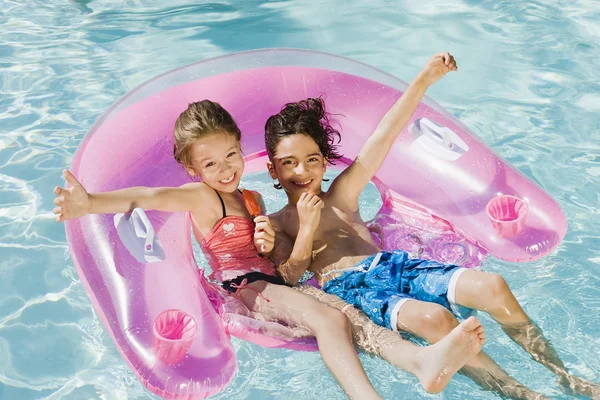 Friends Enjoying In Swimming Pool