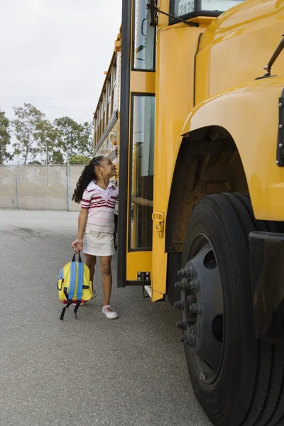 Elementary student near School Bus