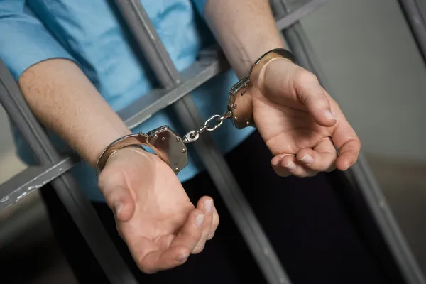Criminal Handcuffed To Bars
