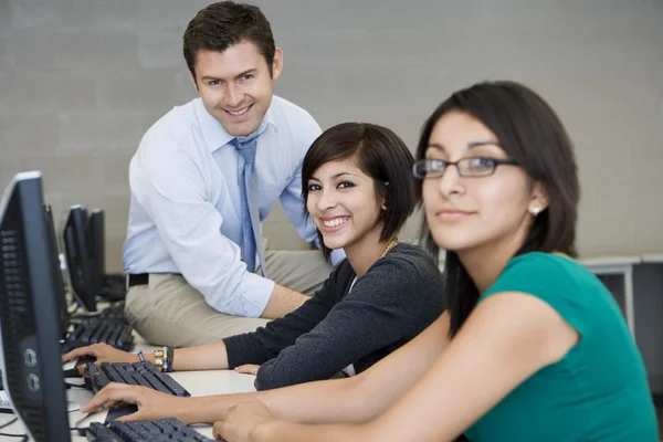 Female Students With Professor In Computer Lab