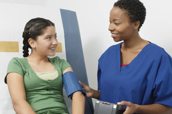 Doctor Checking Girl's Blood Pressure
