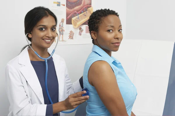 Doctor Examining Patient Using Stethoscope