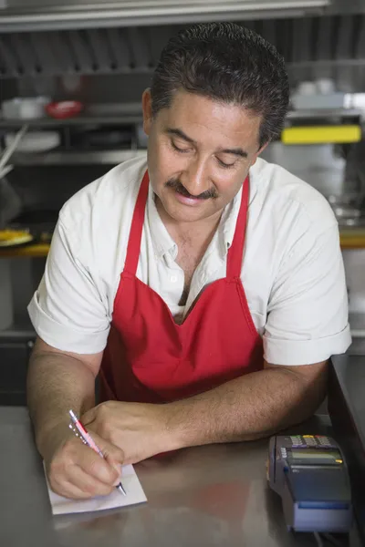 Hispanic Latin man at restaurant counter