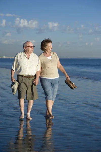 Senior Couple Walking On Beach