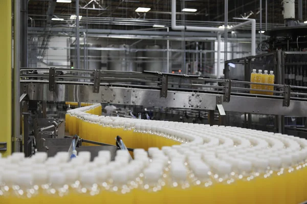 Orange juice bottles on production line