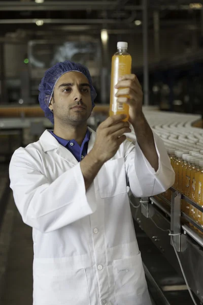 Factory worker with  juice bottle