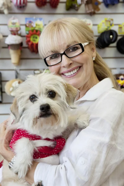 Portrait of senior pet owner shop with dog