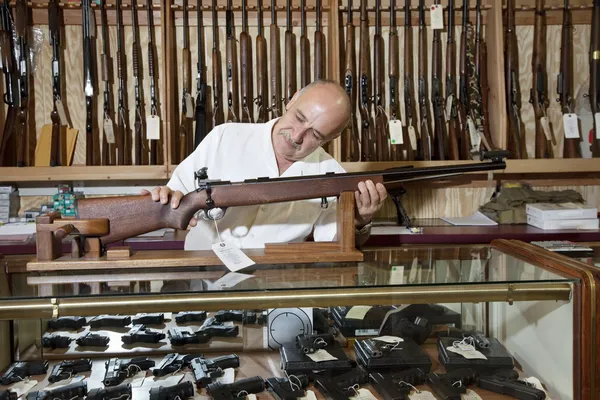 Mature gun shop owner