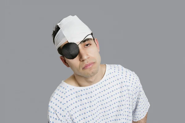 Male patient wearing an eye patch suffering from head injury
