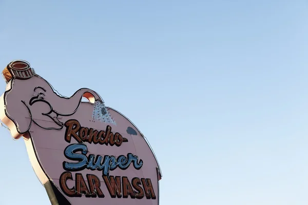 Car wash sign board over clear sky