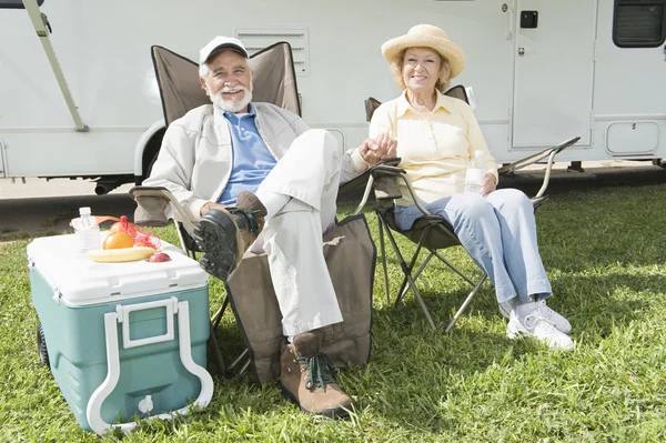 Relaxed Couple Sitting In Folding Chairs