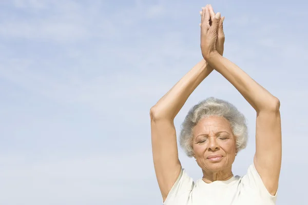 Senior Woman With Eyes Closed In Yoga Pose