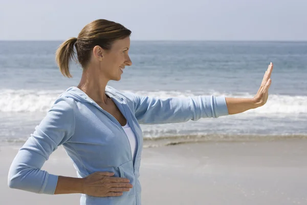 Woman Doing Yoga On Beach