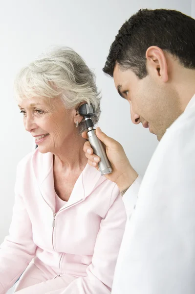 Doctor Checking Patient\'s Ear Using Otoscope