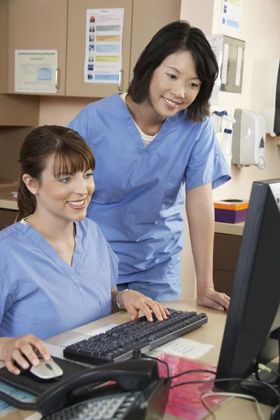 Nurses Using Computer At Clinic