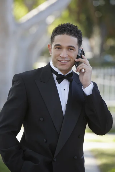 Young Man In Tuxedo Using Cell Phone at Quinceanera
