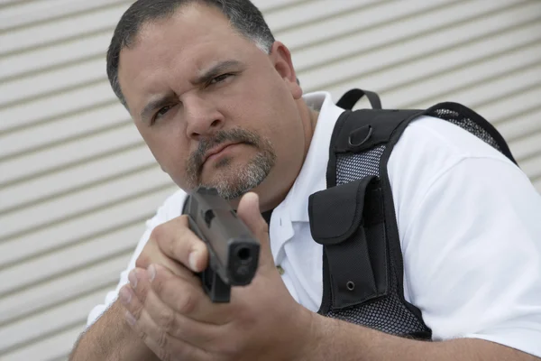 Security Guard In Bulletproof Vest Holding Gun