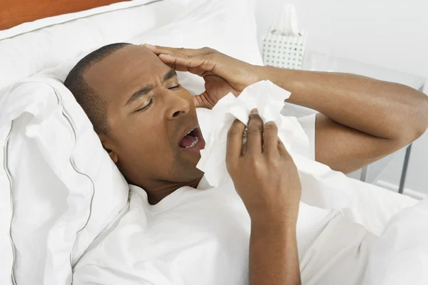Man With Flu In Bed