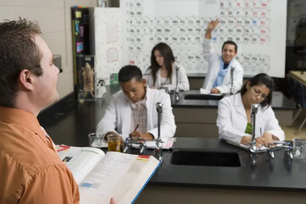 Student Raising Hand In Science Class