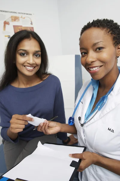 Doctor Giving Prescription To Patient